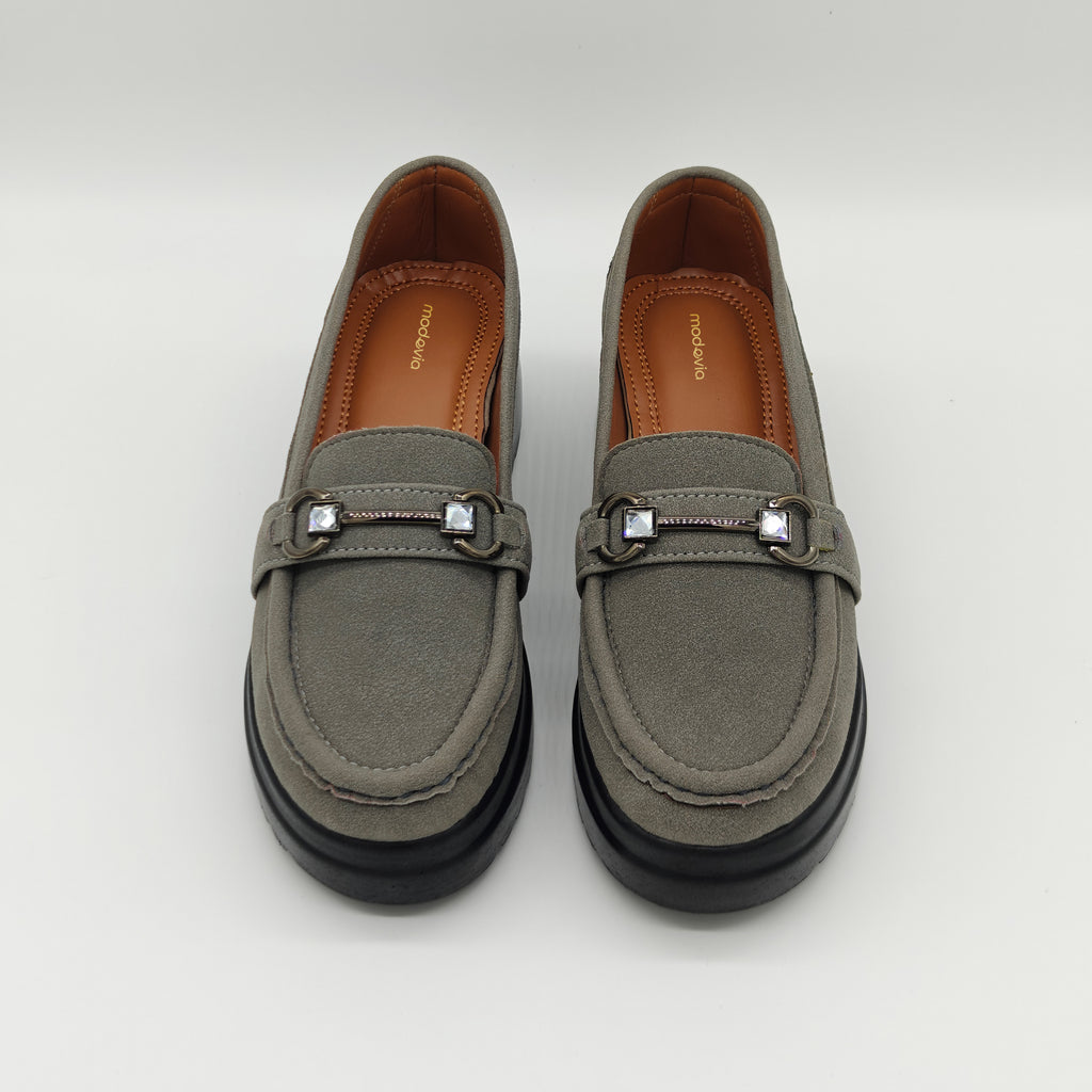 Pair of gray loafers with decorative buckles on a white background