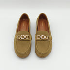 Pair of tan loafers with gold chain detail on a white background