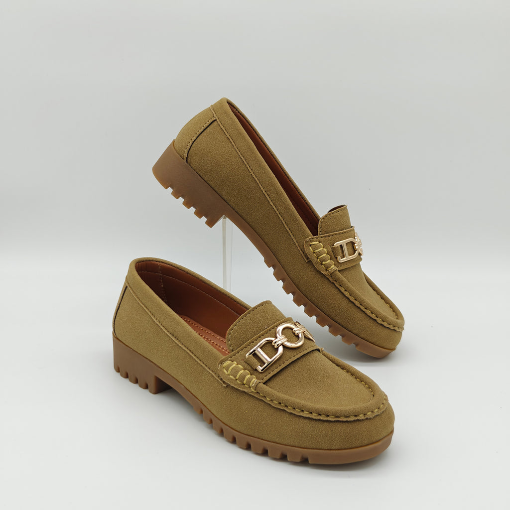 Pair of tan loafers with a gold logo on a light gray background